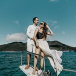 woman in white dress standing on boat during daytime