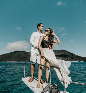 woman in white dress standing on boat during daytime